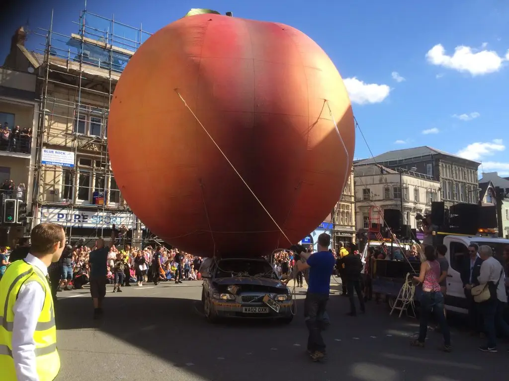Giant Peach rolling down the streets of Cardiff
